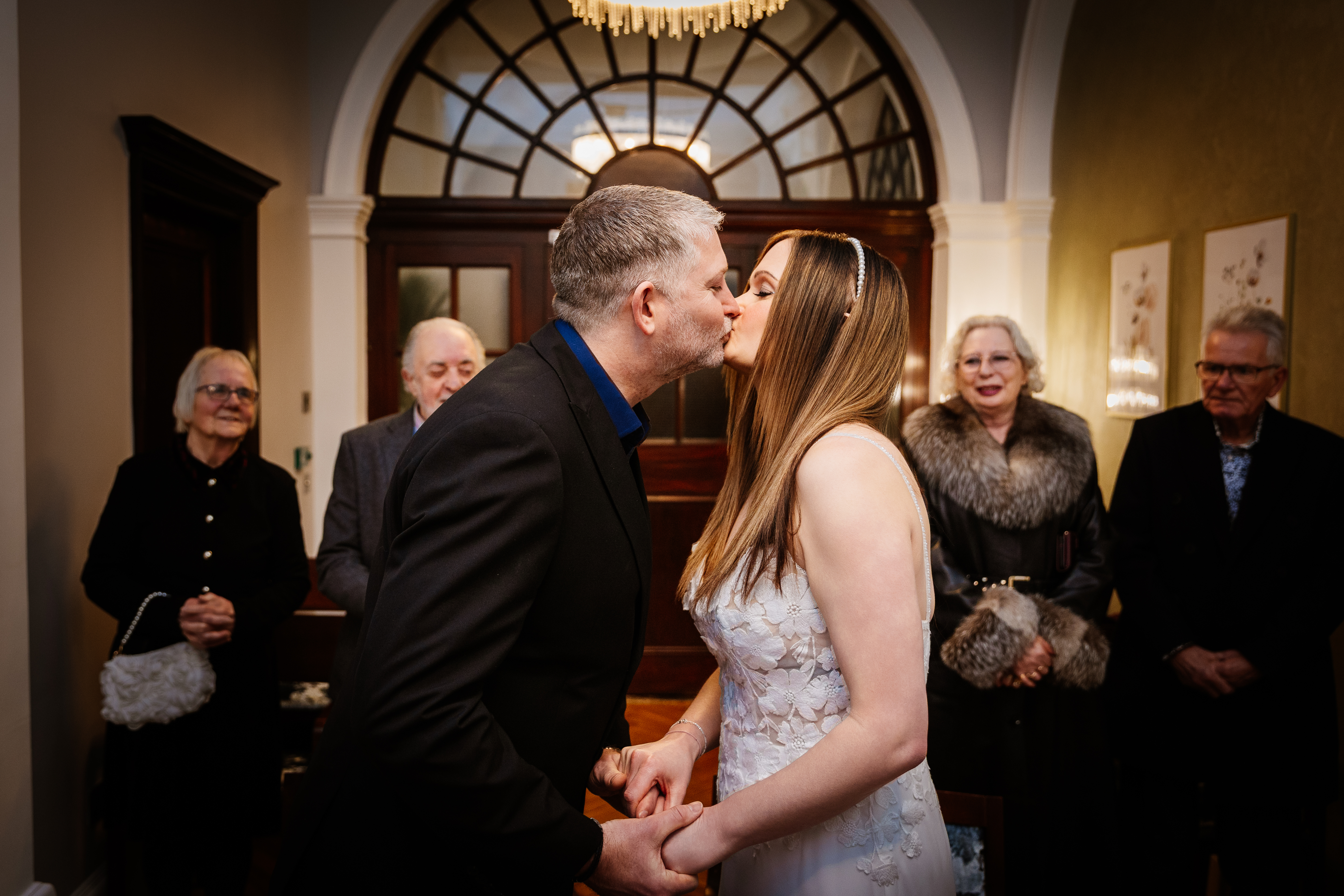 Olivia and Nathan's first kiss in the Harrington Room at Chelsea Town Hall during their intimate London micro wedding